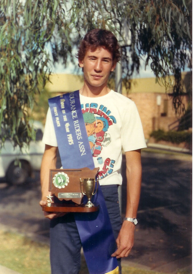 Bruce Neal holding a junior rider of the year trophy (128kb)